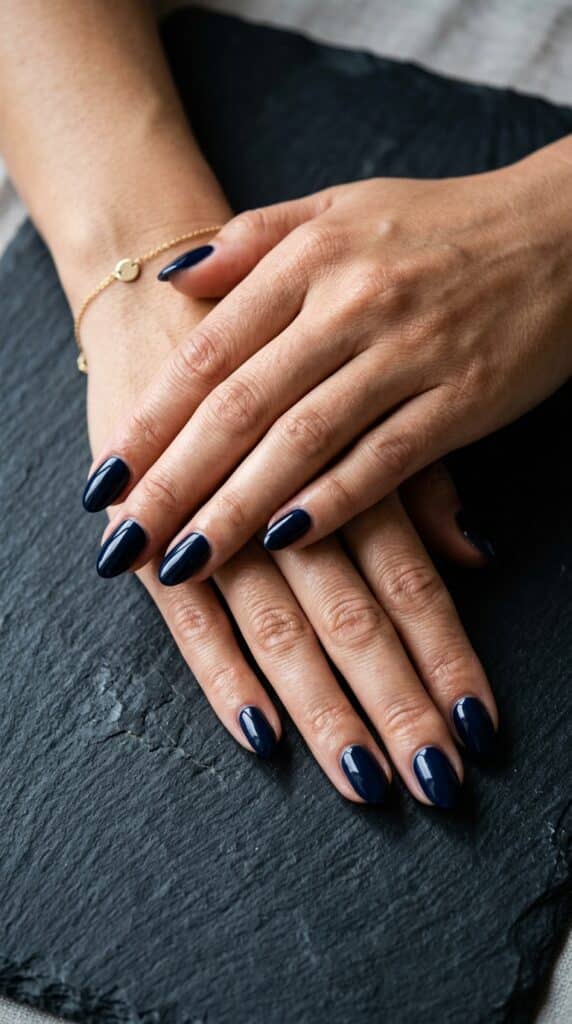25 Stunning Short Almond Nail Ideas for 2026 to Elevate Your Style 9 Two hands navy 202604242236