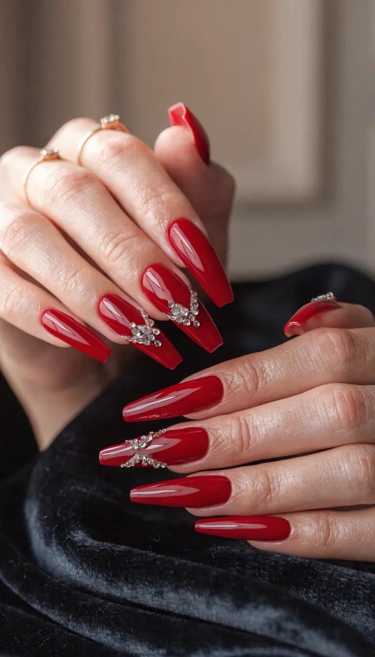 12 Simple Nail Designs You Can Do at Home 8 Close-up of long red manicured nails featuring embellishments on glossy polish