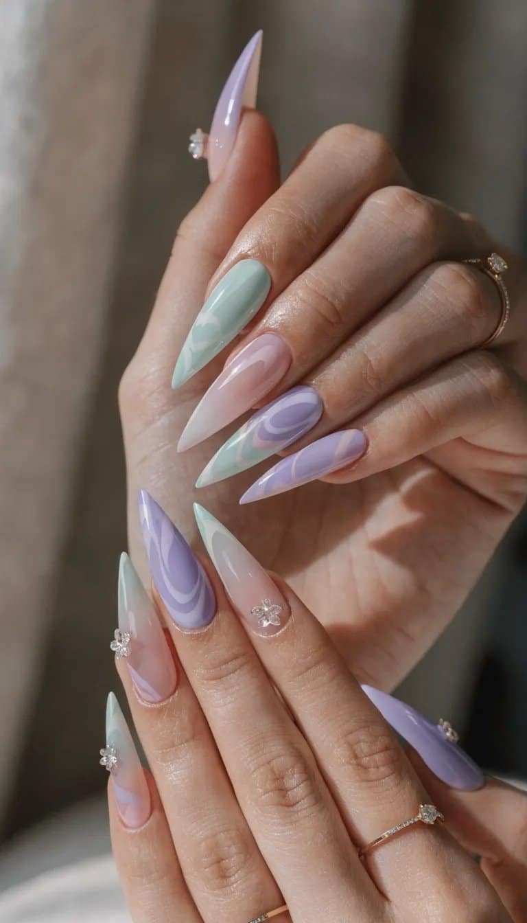 17 Stunning Nail Ideas to Try This Season 14 A set of pastel ombre nails featuring mint, lavender, and baby pink colors with stiletto shapes and decorative gems.