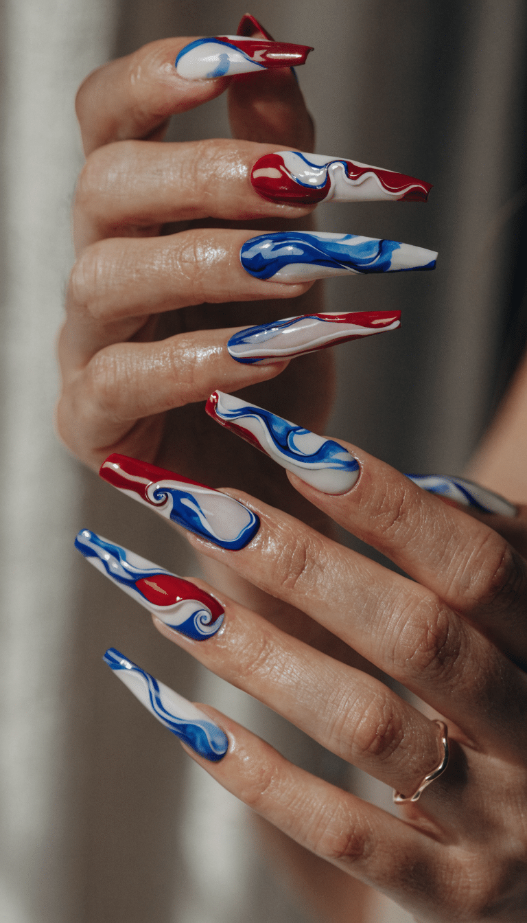 20 Stunning Red, White, and Blue Nail Art Designs for Patriotic Celebrations 17 Long nails featuring abstract red, white, and blue patterns with swirling designs