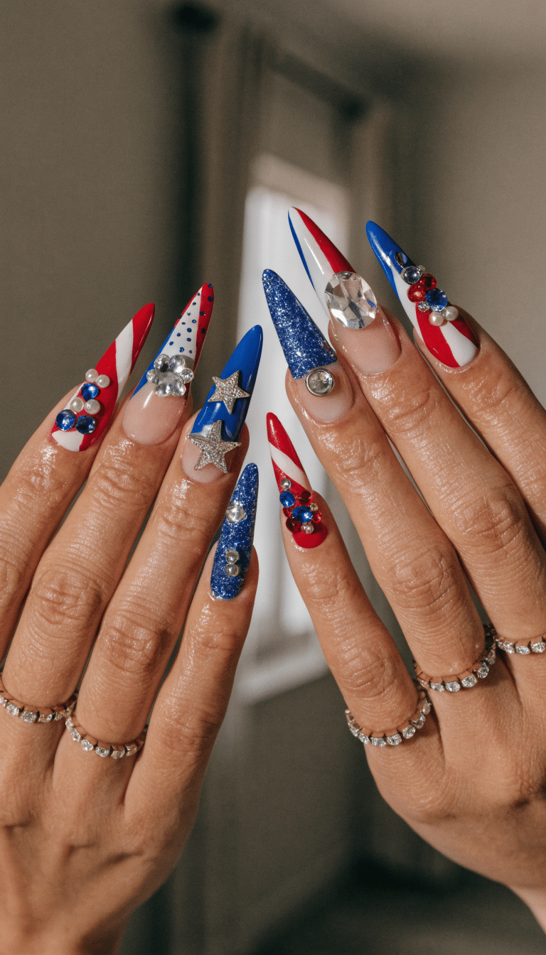 A close-up of festive 4th of July nails with red, white, and blue designs, including star and jewel accents.