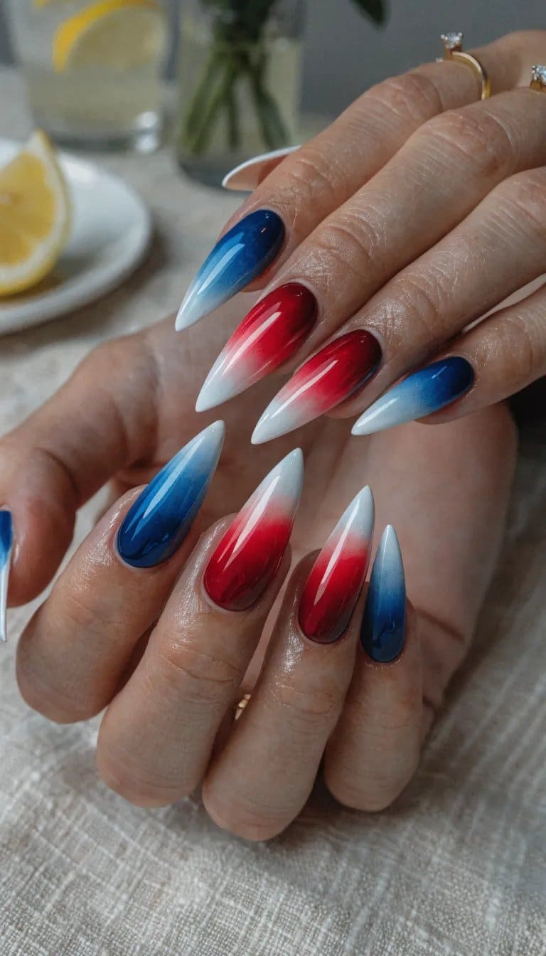Stylish patriotic ombre nails with red, white, and blue colors.