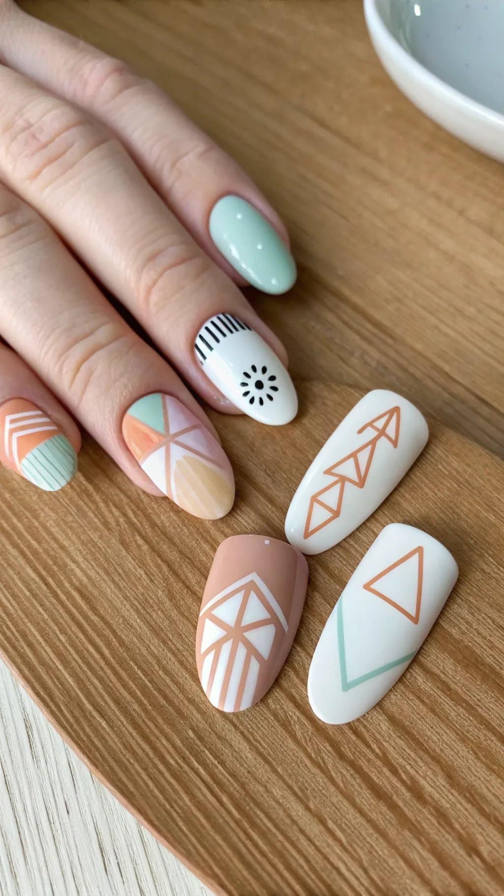 9 Trendy Summer Nail Designs for 2026 9 Nail design featuring minimalist geometric patterns in pastel colors.