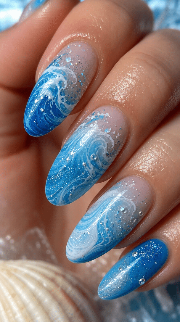Close-up of blue ocean wave nail art with sparkle and shine.