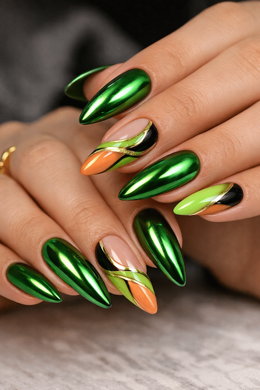 Nails featuring a variety of colors including green chrome, orange, and black in an almond shape.