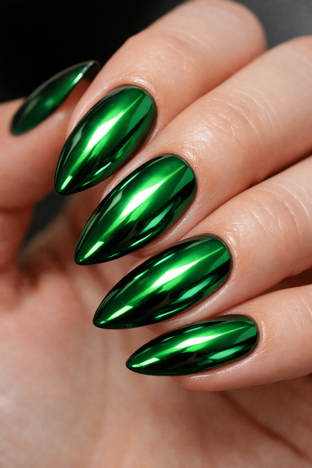 Close-up of sleek green chrome almond nails