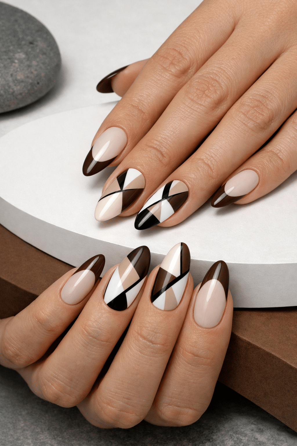Geometric almond nails with brown tips and nude shades